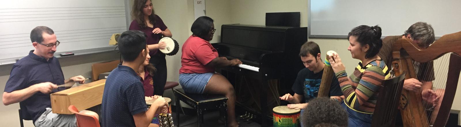 Loyola School of Music Music Therapy Majors practice percussion during improvisation class.