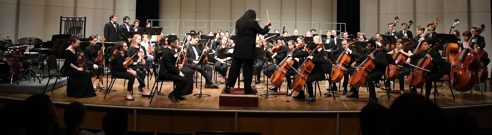 Dr. Montes directing the orchestra in concert 