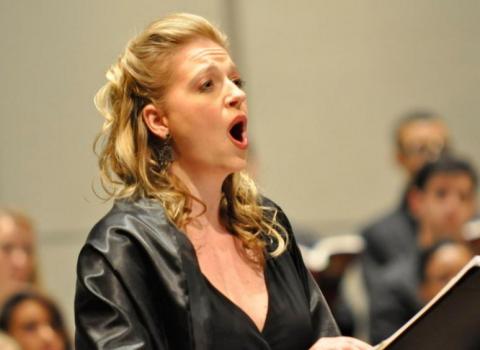 Dr. Betsy Uschkrat sings with a symphony.