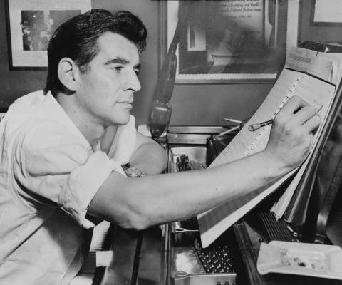 Leonard Bernstein pictured writing music. 