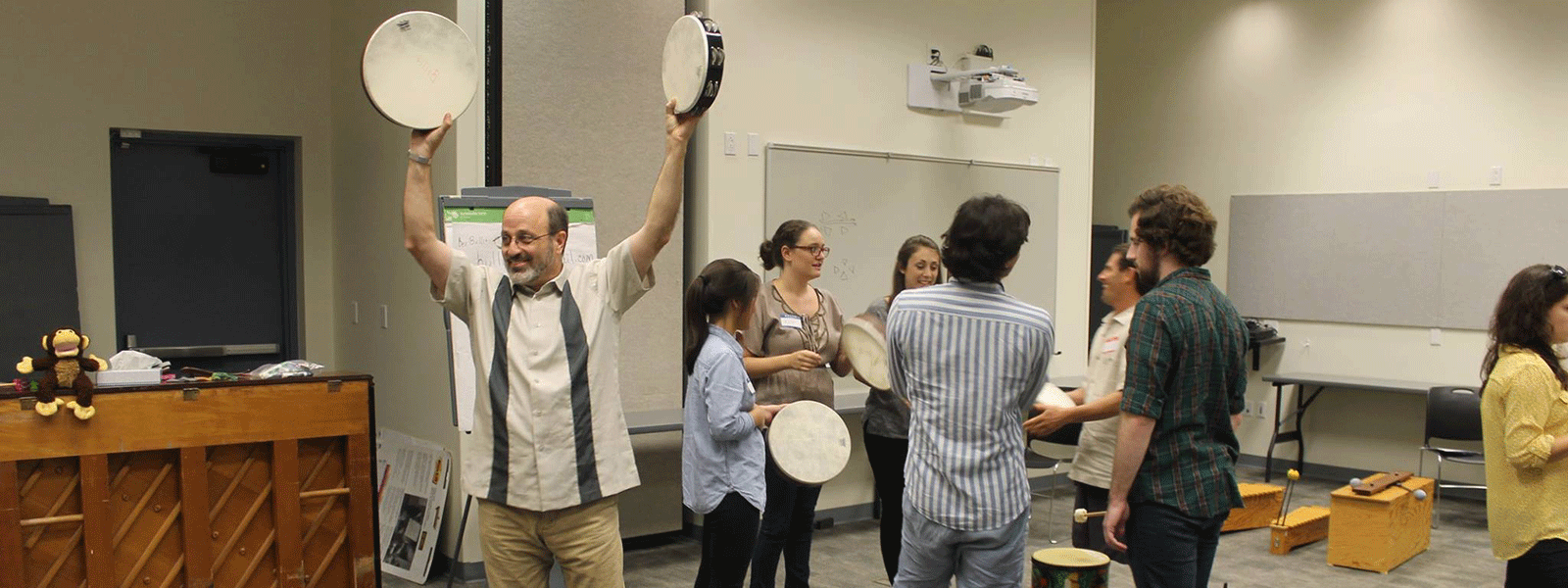 Dr. Robert Amchin teaching Orff music to a roomful of music education students.