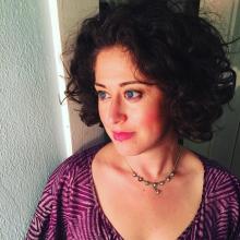 woman, curly hair, purple shirt