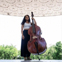 woman white shirt, holding bass